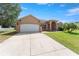 Stunning single-story home with a well-manicured lawn and a two-car garage, perfect for suburban living at 13336 Biscayne Dr, Grand Island, FL 32735