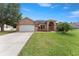 Stunning single-story home with a well-manicured lawn and a two-car garage, perfect for suburban living at 13336 Biscayne Dr, Grand Island, FL 32735