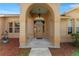 Covered porch and front door of a beige home at 13336 Biscayne Dr, Grand Island, FL 32735