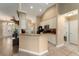 Bright kitchen with tile floors, breakfast bar, and access to a half bath and front door at 13336 Biscayne Dr, Grand Island, FL 32735