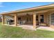 Covered patio with a ceiling fan, outdoor furniture, and an open backyard perfect for entertaining at 13336 Biscayne Dr, Grand Island, FL 32735