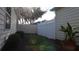 View of landscaped backyard including a vinyl fence, mature trees, and yellow vinyl siding at 1482 Azteca Loop, The Villages, FL 32162
