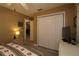 Neutral bedroom features a spacious closet, ceiling fan, and light wood grain floors at 1482 Azteca Loop, The Villages, FL 32162