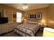 Nicely decorated bedroom with neutral colored walls, ceiling fan, and light wood grain floors at 1482 Azteca Loop, The Villages, FL 32162