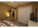 Inviting bedroom features a closet, comfortable bed, light, and an ensuite bathroom for added privacy and convenience at 1482 Azteca Loop, The Villages, FL 32162