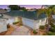 Well-maintained home featuring a two-car garage, mature landscaping, and a charming, quaint design at 1482 Azteca Loop, The Villages, FL 32162