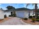 Charming single-story home with a well-maintained lawn, attached garage, and appealing curb appeal at 1482 Azteca Loop, The Villages, FL 32162