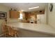 Well-lit kitchen featuring ample countertops and cabinetry, with bar stool seating and appliances at 1482 Azteca Loop, The Villages, FL 32162
