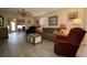 Cozy living room featuring stylish flooring, neutral paint, ceiling fan and comfortable furnishings at 1482 Azteca Loop, The Villages, FL 32162