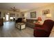 Cozy living room featuring stylish flooring, neutral paint, ceiling fan and comfortable furnishings at 1482 Azteca Loop, The Villages, FL 32162