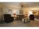 Open-concept living room with stylish flooring and neutral paint provides seamless flow to the kitchen at 1482 Azteca Loop, The Villages, FL 32162