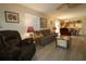 Open-concept living room with stylish flooring and neutral paint provides seamless flow to the kitchen at 1482 Azteca Loop, The Villages, FL 32162