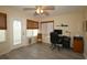 Bright home office featuring a ceiling fan, hardwood floors, woven shades, computer, and view of the backyard at 1482 Azteca Loop, The Villages, FL 32162
