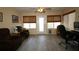 Inviting office space features neutral decor, natural light from three windows, and a comfortable chair for an ideal workspace at 1482 Azteca Loop, The Villages, FL 32162