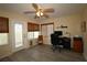 Comfortable office space featuring neutral decor, natural light from three windows, and a comfortable chair for an ideal workspace at 1482 Azteca Loop, The Villages, FL 32162