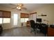 Bright home office featuring a ceiling fan, hardwood floors, woven shades, computer, and view of the backyard at 1482 Azteca Loop, The Villages, FL 32162