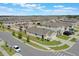 Aerial view of community with uniform homes, lush landscaping, sidewalks and tree lined streets at 1548 Planters Point Rd, Kissimmee, FL 34744