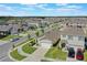 Aerial view of neighborhood showcases sidewalks, similar homes and manicured landscaping at 1548 Planters Point Rd, Kissimmee, FL 34744