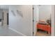 Neutral wall decor in hallway leading to bedroom with twin bed with view of doorway at 1548 Planters Point Rd, Kissimmee, FL 34744