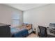 Bright bedroom featuring a comfortable bed, neutral walls, and a functional workspace area at 1548 Planters Point Rd, Kissimmee, FL 34744