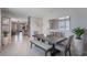 Modern dining area with gray-toned table and bench seating, contemporary decor, and neutral paint at 1548 Planters Point Rd, Kissimmee, FL 34744