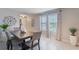 Dining room featuring modern table, neutral walls, and window views with decorative vase at 1548 Planters Point Rd, Kissimmee, FL 34744