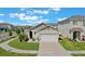 Well-maintained, single-story home featuring a two-car garage, nicely landscaped front yard, and neutral color scheme at 1548 Planters Point Rd, Kissimmee, FL 34744