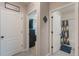 Hallway showing an open bathroom and bedroom with a neutral color scheme and ceramic tile floors at 1548 Planters Point Rd, Kissimmee, FL 34744