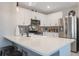 Modern kitchen with white cabinetry, stainless steel appliances, and a spacious quartz countertop island at 1548 Planters Point Rd, Kissimmee, FL 34744