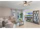 Comfortable living room with neutral tones, a large television, and access to an outdoor view at 1548 Planters Point Rd, Kissimmee, FL 34744