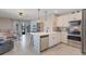 Open living area with a kitchen island, modern appliances, and a comfortable seating area with natural light at 1548 Planters Point Rd, Kissimmee, FL 34744