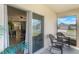 Covered patio with two rocking chairs overlooks the lawn and sliding glass doors lead inside at 1548 Planters Point Rd, Kissimmee, FL 34744