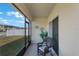 Relaxing screened in patio with wicker rocking chair overlooking the fenced yard at 1548 Planters Point Rd, Kissimmee, FL 34744