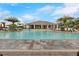 Gathering-friendly community pool featuring a splash area, lounge chairs, and a spacious deck at 1548 Planters Point Rd, Kissimmee, FL 34744