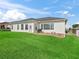 Backyard showcasing well-manicured green grass and the back of the home at 17471 Se 110Th Ter, Summerfield, FL 34491