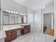 Bathroom boasting double sinks, a large mirror, and a soaking tub near the glass block window at 17471 Se 110Th Ter, Summerfield, FL 34491