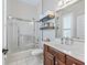 Bathroom featuring a shower over tub, shelves, and a vanity at 17471 Se 110Th Ter, Summerfield, FL 34491