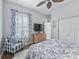 Bedroom featuring blue accents, hard wood floors, a ceiling fan, TV and seating at 17471 Se 110Th Ter, Summerfield, FL 34491