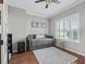Cozy bedroom with daybed, plantation shutters, hardwood floors, and neutral decor at 17471 Se 110Th Ter, Summerfield, FL 34491