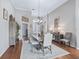 Elegant dining room features hardwood floors, tray ceilings, and views into the foyer at 17471 Se 110Th Ter, Summerfield, FL 34491