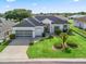 Charming single-story home with a well-manicured lawn, inviting curb appeal, and an attached two-car garage at 17471 Se 110Th Ter, Summerfield, FL 34491