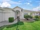 Charming single-story home with an arched entryway, lush landscaping, and well-kept lawn at 17471 Se 110Th Ter, Summerfield, FL 34491