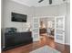 Well-lit office space with white doors, dark wood floors, and built in cabinets at 17471 Se 110Th Ter, Summerfield, FL 34491