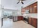 Open-concept kitchen features stainless steel appliances and tile flooring at 17471 Se 110Th Ter, Summerfield, FL 34491
