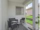 Covered patio featuring stylish outdoor seating and a decorative rug, perfect for relaxation at 17471 Se 110Th Ter, Summerfield, FL 34491