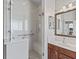 Shower featuring glass doors, a glass block window, a bench and a shower head at 17471 Se 110Th Ter, Summerfield, FL 34491