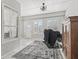 Sunroom featuring tile flooring, shuttered windows, and stylish decor at 17471 Se 110Th Ter, Summerfield, FL 34491