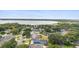 Aerial view of the community showcasing lush landscaping, mature trees, and a lake at 19627 Spring Oak Dr, Eustis, FL 32736