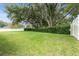 Lush green backyard with manicured hedges and a well-maintained lawn at 19627 Spring Oak Dr, Eustis, FL 32736