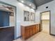 Bathroom featuring a double vanity, bowl sink, tile floor, and access to bedroom and walk-in closet at 19627 Spring Oak Dr, Eustis, FL 32736